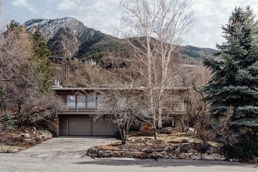For those of us who have been loving on mid-century homes and buildings here in Utah, finding one that still has it's soul, is an absolute real-estate godsend. Be still our 1959 hearts. The simple roofline and facade offer an easy horizontal plane for the magnitude of the mountain view above and at the back. Typical midcentury, taking the natural surroundings into account. Olympus Cove paired with a home featuring an original wood lid and paneling, vaulted ceilings, sky light, and well proportioned rooms, make this house a home worth growing in.     Jen Hadfield, a fellow cityhomeCOLLECTIVE agent, shared these thoughts about this remarkable home:   "Those partial to sprawling valley views will feel right at home here. Expansive picture windows frame the landscape like living art, while a front deck that spans the length of the home invites morning coffee rituals and sunset gatherings alike. Inside, the open kitchen flows seamlessly into the adjoining living space, where high beamed ceilings lend an airy ease to everyday living and effortless hosting. With summer on the horizon, guests can drift from the main living area straight into a backyard poised to burst with perennials-an ideal backdrop for long dinners and lingering conversations. And when the air turns crisp? The original wood stove fireplace becomes the undeniable centerpiece. Picture it now: a crackling fire, a cozy seat, and a glass of something delightful in hand. Beyond its vintage appeal, this home offers practical pleasures, too-a workshop for tinkering and creating, plus a dry sauna for unwinding after a day on the trails. And speaking of trails, you're just a dash from world-class skiing and hiking, with the best of Utah's outdoors practically at your doorstep. Whether you're the entertaining type, the outdoor adventurer, or the contented homebody, this Olympus Cove classic is ready to meet you exactly where you are."   And for our posterity, let's all praise these preserved gems! Kudos to all of the homeowners who have loved on this place over time, and who did so gently and with nature, easy living and mountain majesty in mind! Call for a private showing or come see us at an open house.