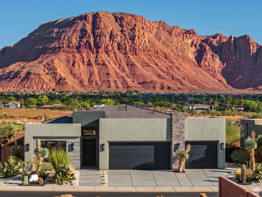 With breathtaking views of the Red Mountain and Southern Utah's iconic red rocks, every day feels like a postcard in this custom Ivins home. Thoughtfully designed, it features 2x6 framing, modern architecture, GE Cafe appliances, an epoxy coated driveway & garage floor, and striking desert landscaping highlighted by incredible saguaro cacti (those things are expensive!). No HOA, yet CC&Rs are in place that keep the neighborhood looking pristine. You'll enjoy both freedom and peace of mind. Ideal for quiet evenings by the fire, entertaining visiting family, or simply soaking in unforgettable sunsets, this home truly stands above the rest. Oh, and, did you see the view? Lease option available. Call for details.