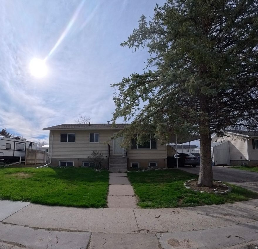 PRIME LOCATION! Seller willing to pay 5,000 towards flooring. Charming multi-level home with great curb appeal and versatile living space! Nestled on a quiet street, this property features a spacious driveway with covered carport, mature trees providing shade, and a well-maintained front yard. The large backyard offers plenty of room to relax or entertain, complete with a storage shed, garden space, and room to customize to your needs. Walkable distance to elementary, middle and high schools!  Inside, you'll find a bright and inviting layout with an open kitchen and dining area. The kitchen is equipped with ample cabinetry, modern countertops, a center island, and updated appliances-perfect for everyday living and hosting. Natural light fills the space, creating a warm and welcoming atmosphere throughout.  Additional highlights include a separate basement entrance, offering potential for added living space, storage, or future customization. With its functional layout, outdoor space, and convenient features, this home is full of opportunity and ready for its next owner.