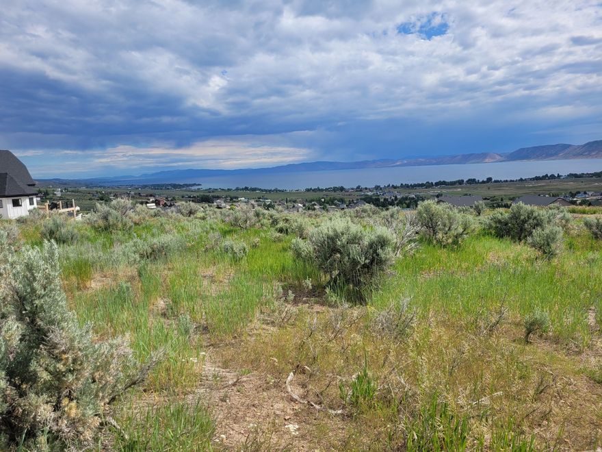 Amazing Property that Sits on the Hill Overlooking All of Bear Lake with Endless unobstructed views of beautiful Blue Lake. "SHORT-TERM RENTALS ALLOWED"!! on this, Larger .41 acre Gently sloped Lot which is perfect for a walkout basement and a large deck. Use our Builder who is familiar with building in this location, or bring your own which makes this an easy lot to build on with protected views of beautiful Bear Lake and the valley. Electrical, Sewer and Water are on easements surrounding the lot and are connected through the HOA. Bear Lake Golf Course 5 min; marina 10 min; Beaver Mtn Ski Resort about 20 minutes away. Can purchase an Ideal Beach Pass in this community to get access to swimming pool, hot tub, private beach, pickleball courts, basketball courts, parks and more for $1,950, Checkout the link @ https://bearlake.org/cat/entertainment Please allow 48 hours to respond to offers and all addenda. This lot is one of the highest lots that allow Short Term Rentals. All Measurements and Lot Information are a courtesy and should be verified by Buyer and Buyer Agent. Please call the Agent to verify your showing time.