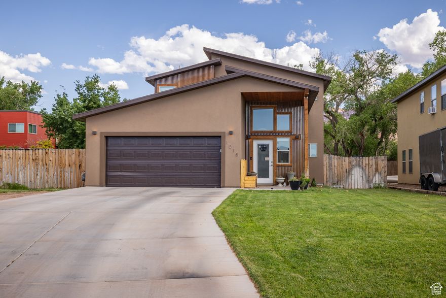 VALLEY VIEWS - A 5-bedroom, 2.5-bathroom sanctuary with superior trail access-welcome to your private gateway to Moab's wild beauty. The 950 square foot main floor of the home celebrates an effortless blend of modern comforts and natural elements. The kitchen, complete with rich wood cabinets, stainless steel appliances and concrete flooring, anchors the main living area, an inviting space perfect for hosting or settling in with loved ones for the evening. The main floor is also home to the spacious primary bedroom, featuring a walk-in closet and an en suite that grants a luxurious double vanity and an artfully tiled shower that feels like a retreat after a long day of adventure. Up the stairs, another 4 bedrooms and a full bath complete the 950 square foot second story. As you step outside to the backyard, you are greeted with a pristine and lush fenced-in yard and a side garden that promises seasons of fresh, homegrown produce, flowers or native vegetation-a perfect 0.16 acres for those with a green thumb. With unbeatable access to Mill Creek Canyon, hiking trails and swimming holes, this is your home  you can hit the trails with ease and take in everything Moab has to offer with the convenience of access to downtown near the Mill Creek Parkway!