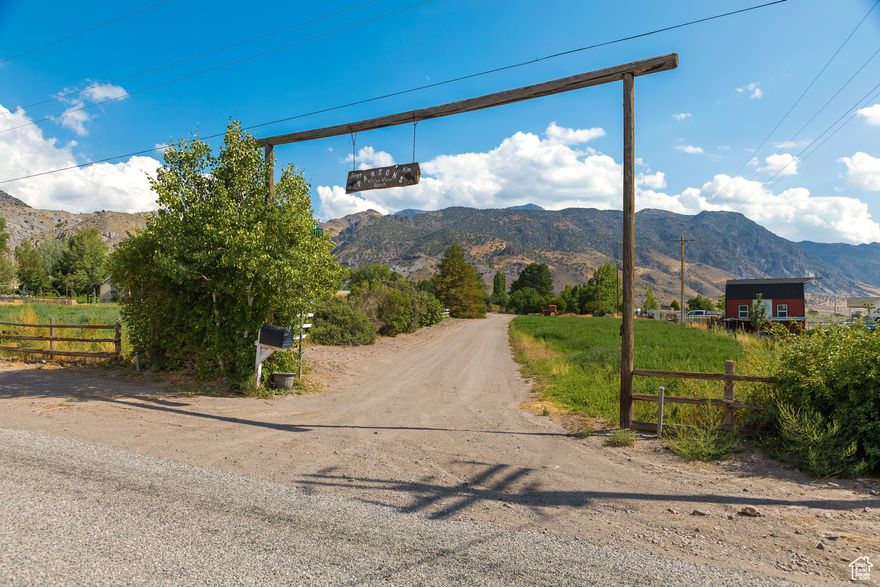 Historic and charming 11.56-acre ranch tucked into the mountains' morning shadow of central-southern Utah. This storybook mini ranch sits at the end of a 385-yard long white fence driveway that wraps around the entire house. Large trees stretch their branches over the final length of the lane like an arched gateway welcoming you into the preserved 95-year-old ranch home. With its serene setting, privacy, views, and historic charm it offers a broad variety of details. This property gives the perfect lifestyle for ranchers, micro-farmers, investors, or those dreaming of a quiet rural retreat out of the busy cities. Please see all photos and the property brochure for more details. This fully functional ranch currently operates as a Rocky Mountain elk and horse farm.  Dotted across the acreage are multiple corrals and holding areas for horses and livestock, approximately  of a mile of 8-foot high livestock fencing, numerous barns, sheds, and storage buildings for equipment, feed, and tools. A city AND irrigation water connection help irrigate the almost 7 acres of peach orchard, garden, park and event area, grass, and alfalfa pastures giving optimal land use and agricultural potential. Adding even more value is another small piece of Monroe town history: the detached ADU, once used as the town's ditch irrigation water shed, has its own lawn, large parking area, and storage shed. This unit was remodeled and converted into a living space that is currently rented for additional income. Whether used as a guest home, caretaker quarters, or continued rental (nightly or long-term) this space enhances the property's versatility. Another true standout feature and possible income producing opportunity is the beautiful park and reception area. Don't miss the photos! This area traps you in a serene and peaceful setting with a viewing deck overlooking a small waterfall creek that runs into a pond - a picturesque setting ideal for hosting weddings, events, or private gatherings. Whether you're looking to live and run a working ranch, enjoy the quiet life while generating multiple streams of income, or simply take in the peace of the country living far away from any neighbors, this property offers unmatched potential and has the flexibility that you are looking for all wrapped up in one bundle. Some acreage can also be subdivided out for buildable lots if you are looking to make some of your money back! Seller is motivated and will look at all offers. Please allow as much notice as possible to schedule showings as the property is currently listed on vacation rental websites. Photos with outlined property boundaries and acreage measurements are used for marketing and information purposes only and are not exact. All details are provided as a courtesy. Buyers and buyer's agents to verify all information. Elk squeeze pen in South pasture will not be included in the sale. If buyer wishes to continue using the property as an elk ranch then some of the elk can be purchased separately.
