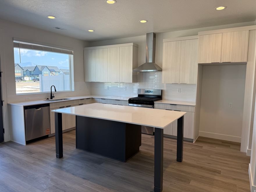 It's your lucky day....Just completed and BEST priced home in the neighborhood with the BEST incentives. $18,000 + to be used towards closing costs and/or interest rate buy down with our preferred lenders. You will not find another townhome with a kitchen like this....butler's pantry, stainless steel hood, tons of cabinets and huge quartz island. Upstairs you'll find three comfortable bedrooms, 2 baths, and a primary suite with large closet. The oversized concrete patio is perfect for private outdoor dining or just relaxing. Smart-home perks are already in place, including a Ring doorbell, keyless entry, Nest thermostat, and integrated Echo system. And the community really sets the stage: miles of walking trails, multiple parks, generous open space, picnic areas, pickleball courts, dog park, and even a fishing pond. Lawn care and snow removal are taken care of, so you can simply enjoy where you live. If you've been searching for a townhome that truly checks every box, this one is a must-see!