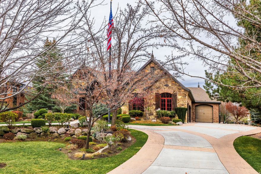 Gated and impeccably maintained custom home in the heart of Holladay. This classic residence features a highly functional floor plan and quality finishes throughout, with only flooring and paint left to update to your personal style. Designed for both everyday comfort and large gatherings, the home offers generous living and entertaining spaces along with convenient main-level living. The main-floor primary suite includes a fireplace, private patio access, dual sinks, and expansive his-and-hers closets. The main level also features a dedicated den/office, formal living and dining rooms, a butler's pantry, and a spacious chef's kitchen equipped with Sub-Zero and Wolf appliances, a breakfast nook, bar area and a great room with cathedral ceilings and west facing wall of windows.  The fully finished lower level provides exceptional additional living space with three ensuite bedrooms, an additional guest room, a large great room with a second kitchen, game room, children's playroom, sizable theater room, laundry room, and two large cold storage rooms.  The private, expansive backyard is ideal for outdoor living. A rare 9-car garage and circular drive complete this exceptional property.