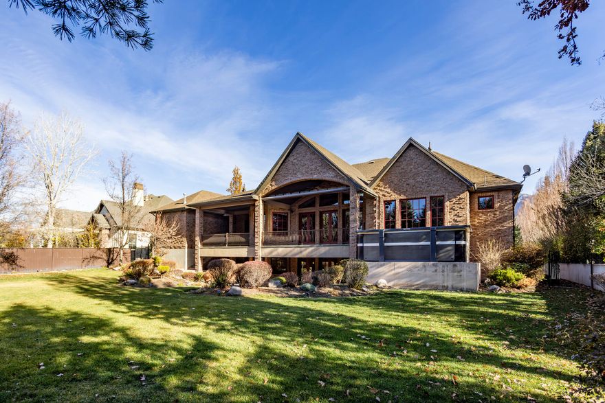 Gated and impeccably maintained custom home in the heart of Holladay. This classic residence features a highly functional floor plan and quality finishes throughout, with only flooring and paint left to update to your personal style. Designed for both everyday comfort and large gatherings, the home offers generous living and entertaining spaces along with convenient main-level living. The main-floor primary suite includes a fireplace, private patio access, dual sinks, and expansive his-and-hers closets. The main level also features a dedicated den/office, formal living and dining rooms, a butler's pantry, and a spacious chef's kitchen equipped with Sub-Zero and Wolf appliances, a breakfast nook, bar area and a great room with cathedral ceilings and west facing wall of windows.  The fully finished lower level provides exceptional additional living space with three ensuite bedrooms, an additional guest room, a large great room with a second kitchen, game room, children's playroom, sizable theater room, laundry room, and two large cold storage rooms.  The private, expansive backyard is ideal for outdoor living. A rare 9-car garage and circular drive complete this exceptional property.