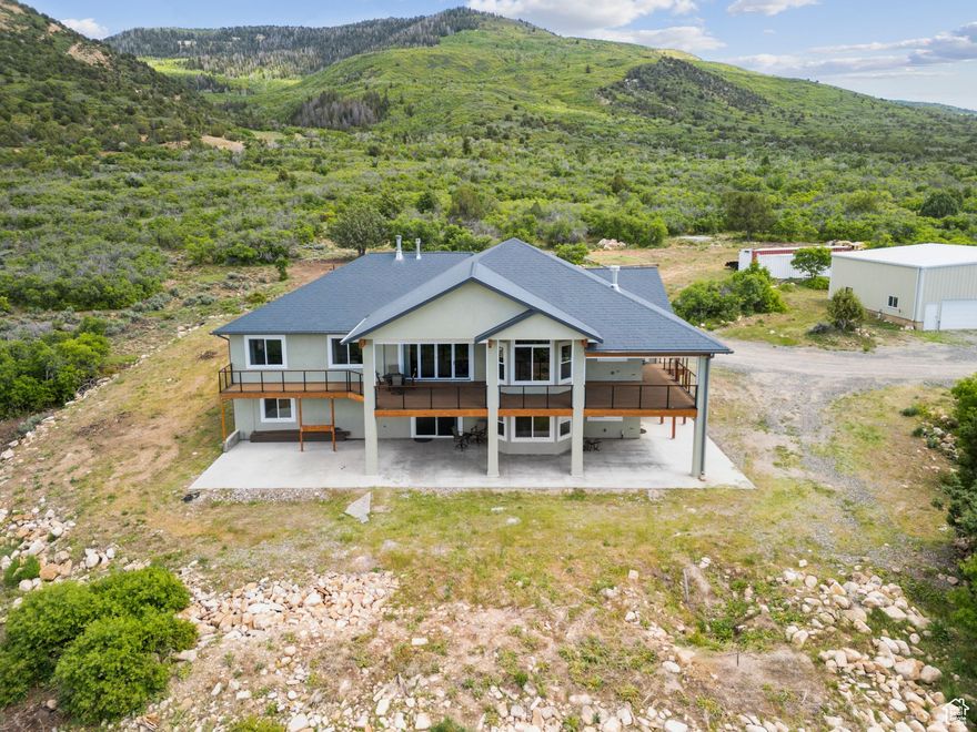 SIGNIFICANT PRICE REDUCTION!! This exceptional 16.1-acre equestrian estate in Milburn, Utah, offers a rare blend of luxury, functionality, and breathtaking scenery. Designed for serious equestrians, it features a 6000+ square foot home, 5 stall barn and exceptional 12,000 square foot partially enclosed riding arena with professional-grade footing.   The riding arena features WiFi controlled lighting and heating, dust control, and mirrors for rider training.  The removable Marine-grade vinyl windows provide year-round comfort while preserving stunning views, and radiant heaters ensure warmth in colder months. The arena is equipped with snow guards, LiftMaster-operated doors, and a 1750 gallon rainwater collection system for sustainable maintenance. An included Arenavator helps maintain ideal footing conditions. The five-stall heated horse barn is meticulously designed for efficiency, comfort, horse health, and safety.  It features five 12' x 16' stalls, two of which can be reconfigured to one 20' x 16' foaling stall.  All stalls have Dutch doors; two have attached walk out pens.  The wash rack with heated water, washing machine, plus the dedicated tack and feed rooms facilitate top-level care. The barn's raised center aisle design, insulated roof, and Piranha fly spray system ensure a comfortable environment. Additional equestrian amenities include a manure spreader, round pen, configurable turnout pens, and a well-planned layout for ease of care and horse movement. Beyond equestrian features, the estate includes a 5,000-gallon water storage, a 50kVA electrical service with a Generac backup generator, and a pre-installed solar transfer switch. Hardwired Cat5e Ethernet and WiFi access points in every structure provide seamless connectivity, while a Lorex security system offers remote monitoring for safety.  With the mobile application, monitoring is available from anywhere with cellular service. The custom, sophisticated 6,000+ sq. ft. home is designed for comfort and convenience, featuring an open floor plan with expansive windows showcasing stunning mountain and valley views. The main-level master suite includes a cedar-lined walk-in closet and spa-inspired bath. The gourmet kitchen boasts Thermador appliances, Subzero refrigeration, trash compactor, and granite countertops - perfect for both everyday use and entertaining. The 1,000-square-foot Trex wraparound deck with remote-controlled sun screens extends the living space outdoors.  The attached oversized three car garage provides ample parking for your vehicles. The lower-level walkout basement offers two additional bedrooms, a full bath with soaking tub, a kitchenette, a living area, two large storage rooms, and a built-in sauna. Additional features such as dual HVAC systems, tankless water heating, chandelier lift, heated exterior concrete, and pre-installed utility connections enhance convenience, efficiency and comfort. A 40'x60' workshop with insulation, with a radiant tube heater, three large garage doors, and plumbing for a restroom offers ample workspace and RV storage. The 14'x30' greenhouse with thermostatically controlled ventilation, water, and 240V/120V electrical service is built for year-round growing and the 12'x40' hay shed with rollup doors on either end provides easy-access and ample storage. With its state-of-the-art equestrian facilities, cutting-edge technology, and luxurious living, this estate is a rare opportunity for horse enthusiasts seeking the ultimate property in Sanpete County, Utah.