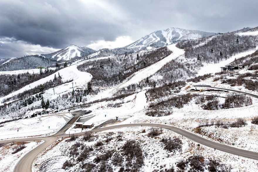 A rare opportunity to build with ease in a premier gated ski community, this gently sloped homesite captures stunning views of the Jordanelle Reservoir and surrounding alpine landscape. Located within Velvaere's luxury community, Estate Lot 09 offers direct trail access connecting to Deer Valley Resort's renowned network of skiing, hiking, and biking trails. Pre-designed architectural plans are available, providing a thoughtful head start toward a custom mountain residence. Velvre is a private, gated enclave of just 115 residences, tucked into the slopes of Deer Valley East Village and served by the Neptune Express high-speed chairlift. Owners ski directly to the lift without base areas or day-skier congestion, supported by advanced snowmaking for consistent winter access. Ownership includes exclusive membership to two amenity-rich clubhouses featuring a private ski beach with aprs lounge and valet, pools and hot tubs, Technogym fitness, Aescape massage, full-service spa, game rooms, and boat club. The Velvaere shuttle connects owners to East Village and historic Main Street. The chairlift is ready for operation, and both clubhouses are anticipated to open Spring 2027. This presents an exceptional opportunity to invest in lifestyle and legacy at the forefront of Deer Valley's East Village expansion. Explore additional custom estate homesites and our 3-to-5-bedroom residences at Velvaere.