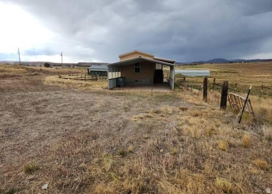 Set on a wide 5-acre spread, this 2-bed, 2-bath manufactured home offers room to grow and the flexibility to shape the property to your needs. Inside, you'll find a functional layout with a central fireplace and a practical kitchen setup, plus a carport for covered parking. The land gives you space for projects, equipment, or future additions. Outdoor recreation is close by with Starvation State Park, Strawberry Reservoir, and the Strawberry River. Explore the potential-schedule your showing today.