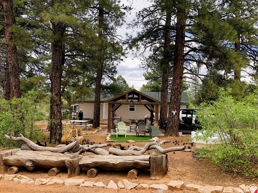 Welcome to the edge of Zion - not the overrun shuttle stop, but the other side. The real side. The side where stars still blink bright and trailheads don't require lines. This 3-bedroom cabin sits tucked beneath towering Ponderosa pines on a rare 2.4-acre double lot, fully connected to the brand-new Zion Peak Water Company, complete with culinary water, fire hydrants, power, septic system, Hughes internet dish, and Direct TV dish. Also includes two 40-foot-high cube containers to store all your toys and more. Everything is ready for comfort, safety, and seamless financing.  This is your chance to invest ahead of the curve, just minutes from the upcoming East Zion Visitor Center, slated to open in early 2026 - a major infrastructure expansion that will forever shift the balance of tourism and value in Southern Utah.  The Cabin - Partially furnished, with warm interiors, a wood-burning fireplace, laundry room, and large bedrooms that invite families and friends to slow down and stay awhile. - Soak under the stars in your private spa after a hike, or gather around the outdoor fire pit and let the canyon silence do the talking. - Thoughtfully positioned with room to grow, expand, or simply preserve your own corner of peace in a busy world.  The Location - East Rim access to Zion's best-kept secrets: Observation Point, Cable Mountain, and Deertrap Mountain, among others. - Ride your bike or take an ATV down miles of scenic trails or head into the Norman Rockwell-esque towns of Orderville and Kanab, where the Wild West meets modern hospitality. - A short drive to the Zion Ponderosa Ranch Resort and all the family-friendly amenities it offers - but far enough for deep privacy and stargazing.  The Investment - Now reduced and priced for smart investors looking to secure a 13C-compatible vacation home with Airbnb approval from the State of Utah. - All infrastructure is in place. No HOA. No hauling water. No guesswork. - This is your opportunity to buy before the East Zion expansion sends prices into the stratosphere.  Zion's East Side is no longer the secret - it's the future. But only a few will own a piece of it.  DM to schedule a visit, stay the weekend, and try the lifestyle before you buy. Your Zion time starts here.