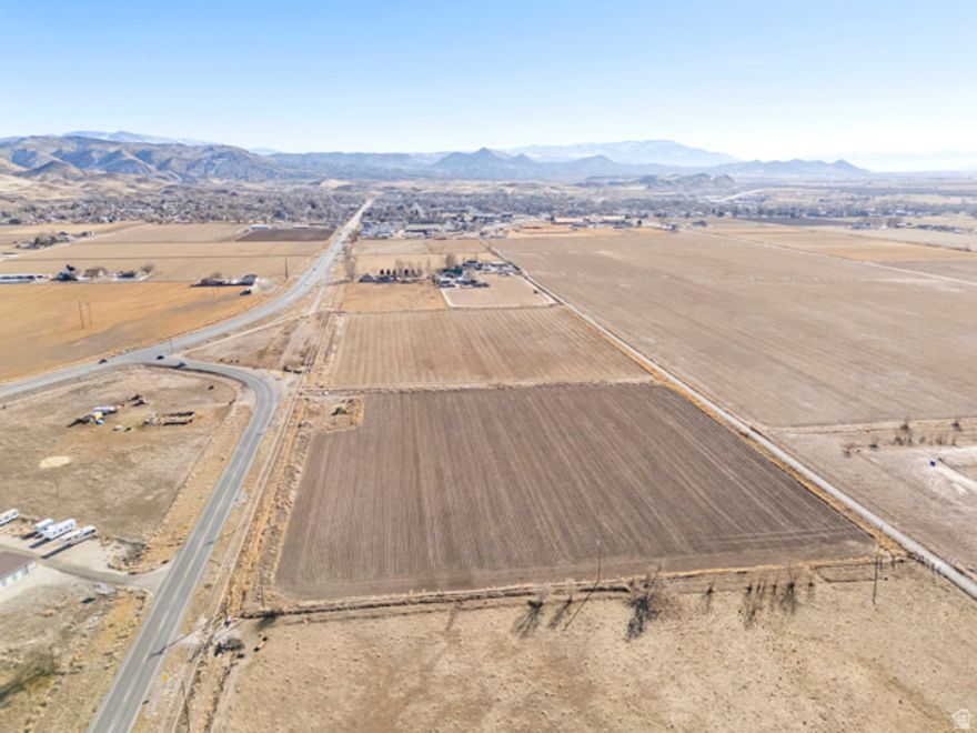 Imagine the freedom of wide-open space with the convenience of town just minutes away. This 19.64 acre parcel offers a rare blend of opportunity, flexibility, and location. With flat, usable terrain currently producing lush hay, the land is ideal for farming, raising animals, or simply enjoying room to roam and grow.  The property includes 2 parcels with a total of 6.25 irrigation shares, adding long-term value and making agricultural use both practical and profitable. Currently designated greenbelt, but offers future potential if you envision building a custom home, creating a small residential development, or holding as a smart investment. In close proximity, a property with an existing home means utilities and sewer connections are conveniently close, simplifying future plans.  Easy access from SR-256 and The Salina Redmond bike path which runs along the property, keeps you connected while preserving a peaceful, rural setting. Located near the high school and just beyond the heart of town, this land strikes the perfect balance between privacy and proximity.  Versatile. Productive. Full of promise. This is your chance to own acreage that works for today and adapts beautifully for tomorrow.