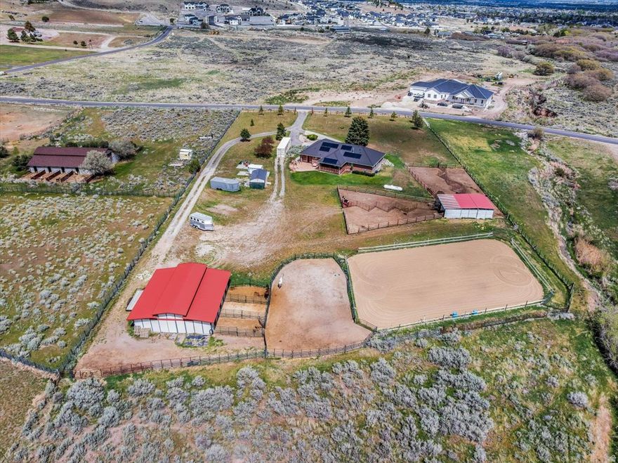 Live the kind of lifestyle that gives you space to breathe, roam, and explore-set on 2.8 acres in desirable Hi Country Estates near Rose Canyon, just minutes from Yellow Fork Canyon's scenic trail system for hiking, horseback riding, biking, and snowshoeing. This fully fenced horse property is thoughtfully set up for both everyday living and long-term flexibility. The walk-out basement offers excellent potential for a future ADU-ideal for multi-generational living or added income. Equestrian amenities are already in place with two barns and a shed. The 36x36 barn includes an arena, three stalls, tack room, and generous hay storage, while the 36x24 barn adds four more stalls and additional storage. Each stall is equipped with its own water source, making care simple and efficient. Recent updates provide peace of mind, including a newer furnace and AC (2021), paid-off solar, and 30-year shingles installed in 2017. The home also features a whole house humidifier, water softener (2026), and an included garage air compressor with built-in hose access-perfect for tools, toys, and keeping everything ready to go. Whether you're bringing horses, hobbies, or simply craving open space and connection to the outdoors, this property offers a rare opportunity to create the lifestyle you've been looking for.