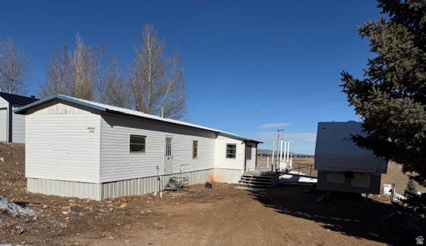 Single-wide trailer currently under renovation and not in a livable condition.  This is a great opportunity for an investor or buyer looking to customize and add value.  Buyer may continue the remodel or choose to remove the structure: a demolition bid from a local contractor is available upon request.  The property includes a 2002 Forrest River Toy-hauler fifth wheel trailer, providing a convenient place to stay during the remodel.  Located in a desirable community featuring a swimming pool, park and playground.  The golf course is just a few minutes away.  Enjoy easy access to the lake which is just a short distance away.. There is something for everyone to do in this small town feeling community.  Making this the ideal spot for outdoor enthusiasts or those looking to enjoy a comfortable year round living. Short term rentals are not allowed.