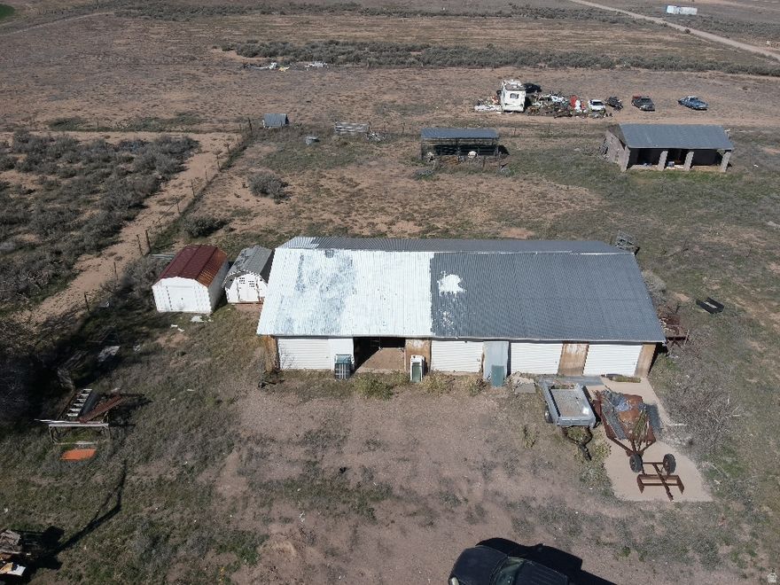 1.02 flat acres in Escalante Valley Ranchos, Beryl, UT. This lot is loaded with value! 5-bay shop w/ 500-amp power, 2-stall barn and 1 acre-ft water rights. No HOA, no easements. Right off SR-18 with ample room at the front to build while preserving every existing structure. Versatile, unrestricted, and ready to go!