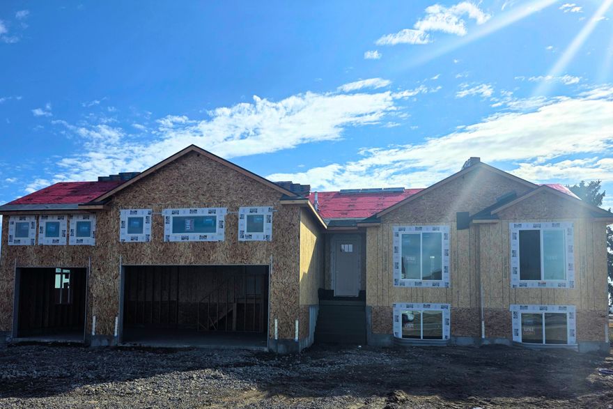 Welcome the SUNBROOK to the family!  Brand new, stunning floor plan  under construction in Elwood. This impressive 3,176 sq ft single-level home offers a perfect blend of style, space, and modern functionality. Featuring 3 bedrooms and 2 bathrooms, the open-concept floor plan is ideal for entertaining and everyday living alike. The heart of the home is a spacious great room with a cozy fireplace, flowing seamlessly into a chef-inspired kitchen with stained cabinets, a stainless steel gas range, and beautiful pendant lighting. Elegant wrought iron railings and luxury vinyl plank flooring add sophistication and durability throughout the main living areas.  The large master bedroom features a master bathroom with a spacious walk-in shower and a relaxing soaker tub-perfect for unwinding after a long day, flowing seamlessly to a generous walk-in closet. Car enthusiasts  will love the 3-car garage. The exterior features a Hardie board front, combining low maintenance with timeless curb appeal, while the unfinished basement provides incredible potential for future expansion. Every detail of this under-construction rambler is designed with quality and style in mind. Don't miss the chance to make this Elwood beauty your dream home and add your personal touches before it's complete!