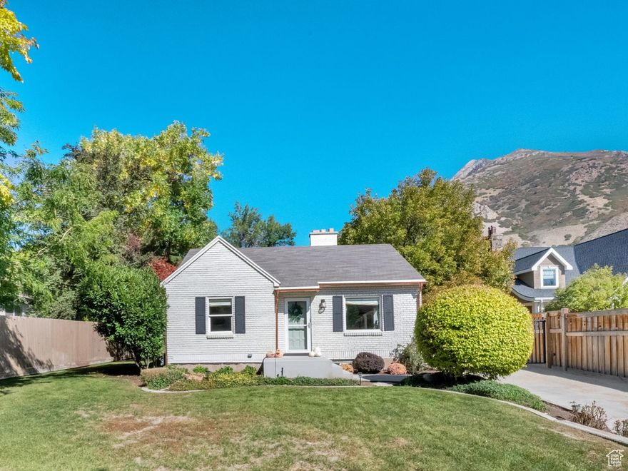 So much to say about this beautiful and charming home on a HALF-ACRE lot on Holladay Blvd. In one of the most sought after neighborhoods in all of Salt Lake City, this home has been thoughtfully and carefully preserved to make it the gem that it is!   Inside, the home has been tastefully designed and renovated. Every room is dripping with charm! The bedrooms have been decorated and curated with care. In the basement, indulge in a beautifully redone shower with double heads and stunning tile work. You will also appreciate the high end finishes, stylish wallpaper, and fresh paint throughout most of the home, both inside AND out!   The backyard is shaded by mature Oak and Cottonwood trees. On the newly poured patio--complete with hookups for a grill and hot tub-- you can unwind by the firepit or enjoy the privacy of the fully fenced yard.  The extra large detached garage has an additional storage room with floor to ceiling storage shelves, as well as incredible wall to wall cabinets for easy organization of ALL your tools and gadgets. If that's not enough, there is additional storage in the shed(s)! Exterior string lights around the yard will make those summer nights even sweeter. Hydrangeas are maturing in the front yard, and rose bushes along the side of the home!   Other recent upgrades include: Brand new copper gutters - they look great! House was painted in the last year. Front and back patios are brand new concrete! Tankless water heater new in the last 3 years. The south side fence is new in the last 3 years. Furnace within the last 5 years.   The home is lovely and in great shape, and the lot is something truly special! Don't miss your chance to claim this beautiful slice of Holladay!