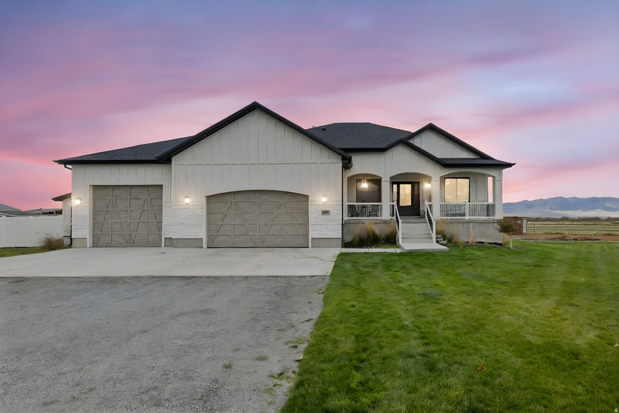 Who's ready for an amazing home in Erda on an acre!? This is THE one! Tucked away at the end of a charming cul-de-sac, this home immediately welcomes you with a beautiful front porch, professionally installed trim lighting, lush green grass, a spacious 3-car garage, and plenty of extra parking-perfect for guests, RVs, or all your toys! Step inside through a warm, inviting entryway that sets the tone for the rest of this stunning home. The enormous open-concept family room and kitchen will have you wondering which direction to look first! The family room features a gorgeous floor-to-ceiling fireplace, huge windows that fill the space with natural light, and room for a large dining table. The kitchen is an absolute showstopper-featuring elegant light fixtures, beautiful cabinetry, a tremendous island, walk-in pantry, granite countertops, a convenient pot filler, stylish backsplash, and a built-in desk area. The spacious master suite offers privacy from the guest rooms and includes a luxurious bathroom with a huge soaking tub and walk-in shower. On the main level, you'll also find two additional bedrooms and a bonus room that's perfect for an office or extra bedroom. The conveniently located laundry room-with an adorable Dutch door-is a must-see! Downstairs welcomes you with a second large family room featuring another fireplace. The basement includes two oversized bedrooms, a full bathroom, a home theatre (complete with seating, projector, and sound system!), and a versatile room perfect for a gym, playroom, or extra storage-plus a large cold storage area. The home is equipped with two water heaters, ensuring plenty of hot water for the whole household. Step outside to enjoy the peaceful backyard, which backs up to the Erda Sod Farm-no backyard neighbors! The chicken coop stays, and the deck, though unfinished, offers incredible potential and amazing views. The heated garage is every homeowner's dream, offering plenty of extra space for hobbies or projects. There's so much to love-you'll just have to come see it for yourself. Come fall in love with your next home!