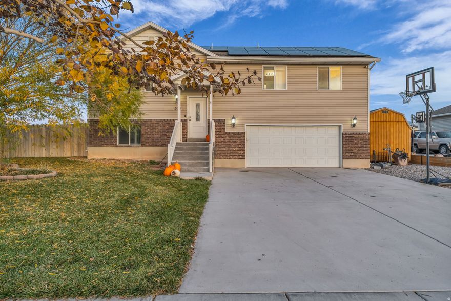 Experience comfort, style, and modern efficiency in this beautifully maintained 3-bedroom, 2-bath home in Tremonton. Built in 2014, this property offers long-term value with fully owned solar panels installed in 2021, providing dependable energy savings month after month. The open-concept main level features vaulted ceilings and generous natural light. The kitchen stands out with rich knotty alder cabinetry, granite countertops, and quality appliances, creating a warm and functional space for cooking, dining, and gathering. The adjoining living area offers a clean, comfortable layout ideal for everyday life. The private primary suite provides a relaxed place to unwind, with a well-designed bathroom and practical closet space that keeps the room open and uncluttered. Throughout the home, a mix of hand-scraped hardwood, tile, and carpet adds durability and comfort where it matters. The unfinished basement provides significant room for expansion, giving you the option to add future bedrooms, a family room, storage, or custom space tailored to your needs. Outside, the fully fenced backyard is a key highlight. You'll find a spacious patio that's perfect for outdoor dining, grilling, or entertaining, along with plenty of lawn space for kids, pets, or projects. A large 1220 shed adds excellent storage or potential workspace, a rare bonus in this price range. Mature trees and a quiet setting give the yard added privacy and charm. With a low-maintenance vinyl and brick exterior, an attached two-car garage, and convenient access to parks, schools, and local amenities, this home combines capability, comfort, and location in a highly functional package. Homes with this kind of space and flexibility don't come around often.