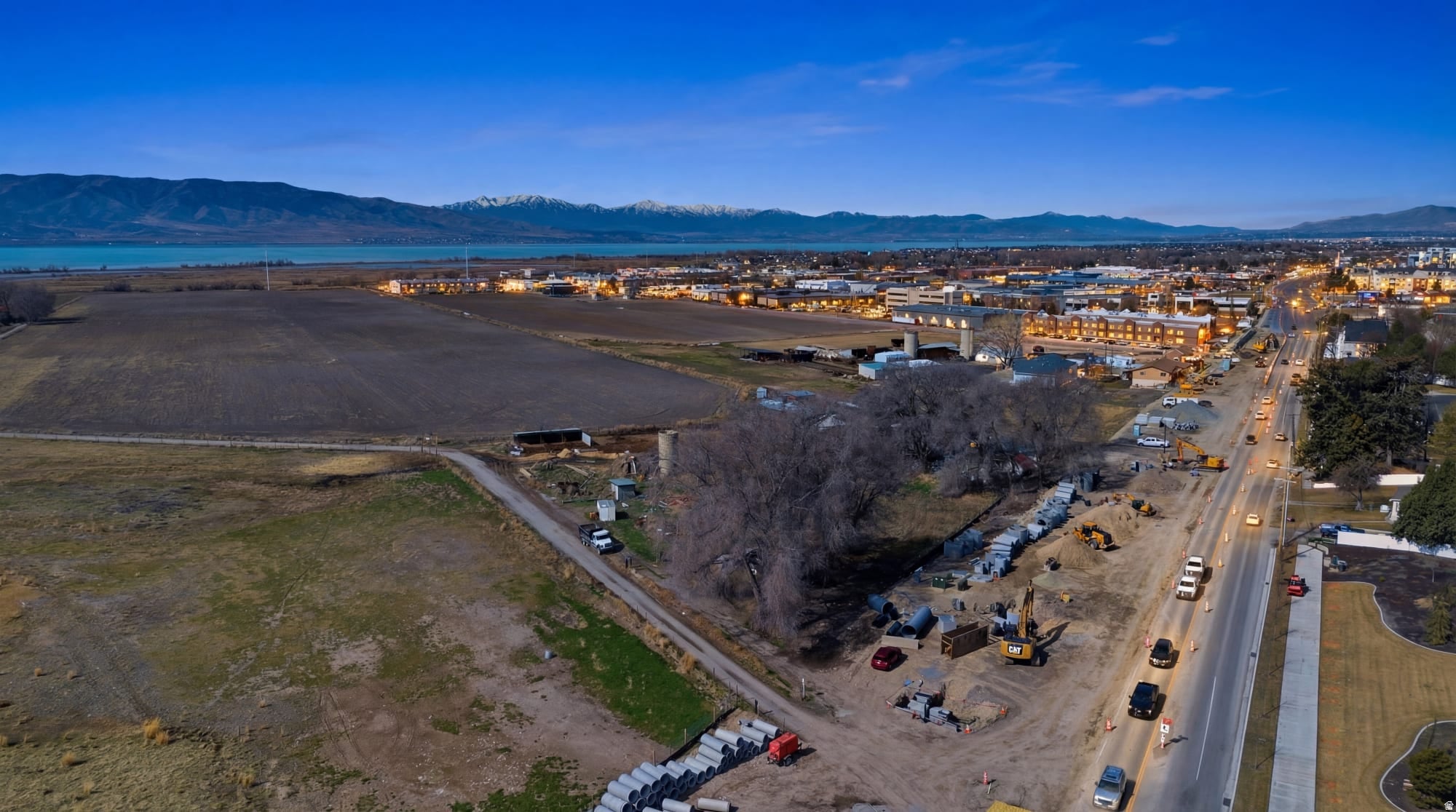 Expansive undeveloped land featuring a broad, flat terrain, bordered by a paved road