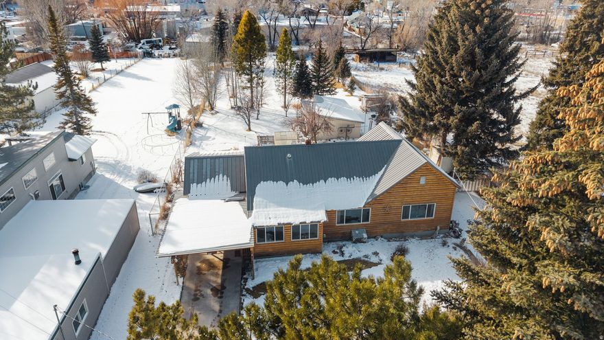 One of a kind Montpelier home with log siding, a sunroom entrance, a separate dining area with a freestanding gas fireplace, and a living room. Upstairs has a bedroom, while the lower level includes a family room, storage, and a jetted tub. Outside, the property offers an attached garage, extra covered parking, and a half-circle driveway. Mature trees frame a surprisingly large backyard for an in-town lot, complete with a greenhouse and fruit trees including plum, chokecherry, and four varieties of apples. A 20x20 shop, two metal sheds, and a hay barn provide plenty of practical space. Everything you need is close by schools, parks, shopping, and even the golf course making this a rare combination of usable land and convenient location.