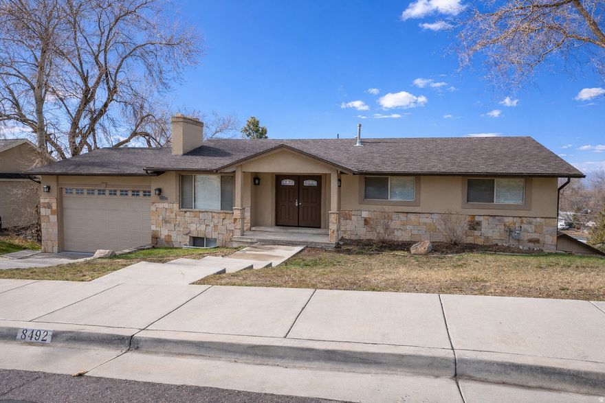 **Newly Updated**  This exceptional single-family home in a prime Sandy location offers space, versatility, and breathtaking views on a generous .34-acre lot. Enjoy close proximity to parks, shopping, dining, entertainment, golf courses, and the Sandy Amphitheater-while still feeling tucked away in a private, scenic setting. This beautifully updated home features fresh paint, new laminate flooring throughout, a new stove and range hood vented to the exterior of the home, new blinds and closet doors, new toilets in all bathrooms, new double sink vanity and mirrors in the primary bathroom, and new epoxy flooring in the garage. The main-level has a spacious open-concept design and includes the primary bedroom and bathroom, complemented by two additional bedrooms and another full bathroom for convenient single-level living. The first walk-out basement expands the home's versatility, offering a full second kitchen, a large family room, three additional bedrooms, and a full bathroom-perfect for guests, extended family, or multi-generational living. The second walk-out basement adds even more living space with an oversized family room and an additional bedroom. Outdoor living is a true highlight, with incredible views from two expansive decks spanning multiple levels and a ground level patio. All decks have been freshly repainted, creating the perfect setting for relaxing evenings and entertaining. With multiple living areas, flexible layouts, and room for everyone, this home is a rare opportunity to enjoy comfort, functionality, and stunning views in one of Sandy's most desirable locations. Square footage figures are provided as a courtesy estimate only.  Buyer is advised to obtain an independent measurement.