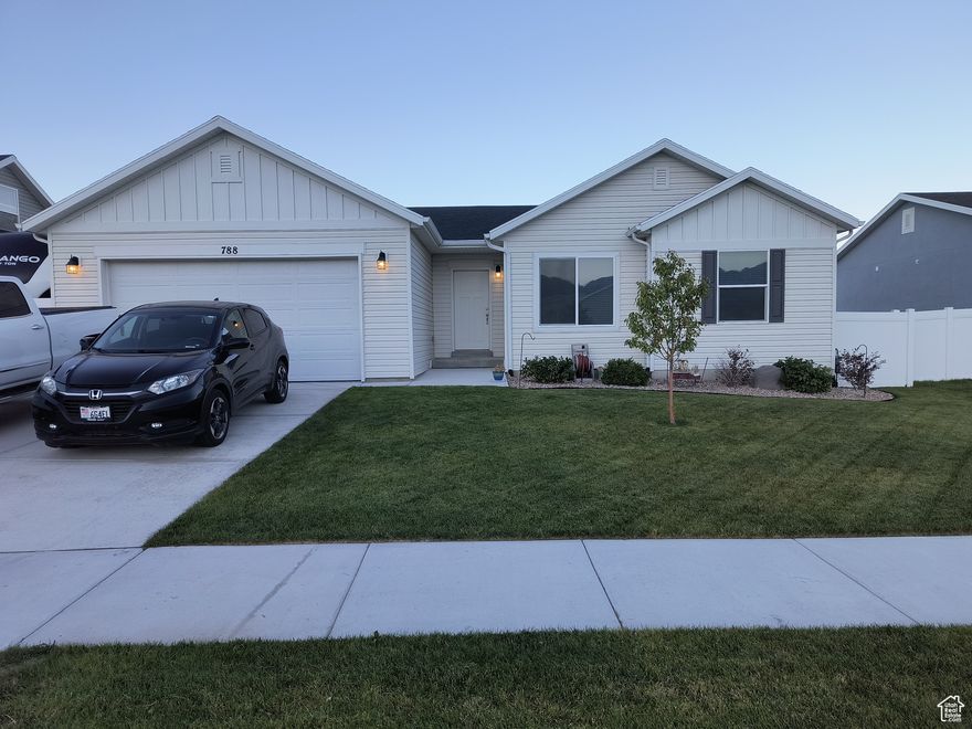 Welcome home to this charming 3 bed, 2 bath Energy Star rambler in Grantsville! Built in 2020, this modern gem boasts an open-concept living space with plenty of natural light, vaulted ceilings and stylish finishes throughout.  The spacious kitchen features sleek granite countertops  full highth cabinets and ample storage.  Upgrades include insulated garage with 50 amp plug inside and out. Double sinks in principal bathroom, gas stove with electric hook up option, silent, soft and water resistant flooring, Larsen storm door, 3 car garage (3rd is tandem) covered porch, RV parking ,laundry/mud room, unfinished insulated basement  with electrical and plumbing .