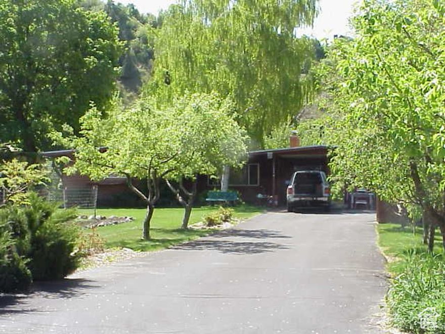 Hear the Logan River from the bedroom. Very private setting. Four bedrooms, 1.75 baths, nice kitchen and large sunroom. Outdoor stove area and barbeque on a covered patio. Large shade trees and lots of fruit trees. Several storage sheds. A very unique property.