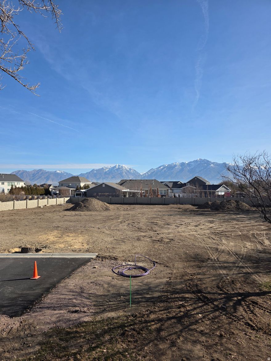 Amazing opportunity to build your dream home on a 1/2-acre lot in Riverton! Lot #2 offers gorgeous views of the Wasatch Mountains. Near shops, restaurants, and movie theaters, as well as close access to Bangerter Highway and Mountain View Corridor!   Culinary and secondary water stubbed into lot. Sewer stubbed into lot. Curbing and lane complete.