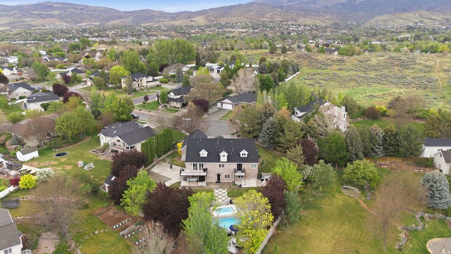 Completely remodeled in 2022, this exceptional Alpine estate sits on a quiet cul-de-sac and blends luxury with thoughtful design throughout. Highlights include beautiful new wood gridded and non-gridded Pella windows, European white oak floors, iron doors, and a Gourmet Chef's Kitchen with a 12x5 walnut island, quartzite surfaces, 48-inch 6-burner Thermador range with griddle stove, 36-inch SubZero fridge, 36-inch SubZero freezer, 2 Bosch dishwashers, 2 warming drawers, and 2 butler's pantries. The lower level features a mother-in-law apartment with private entrance, full kitchen, laundry, bath, and 2 bedrooms. Resort-style backyard offers 2 fiberglass saltwater pools, the second pool  seats 20+, heats above 100 degrees for a hot tub, or chills to approximately 42 degrees for cold plunges. Plus a regulation-size pickleball court/basketball court and mature landscaping. New roof in 2020. Minutes from American Fork Canyon, Alpine Country Club, Cedar Hills Golf Club, multiple parks, and Thanksgiving Point for shopping, dining, and entertainment.