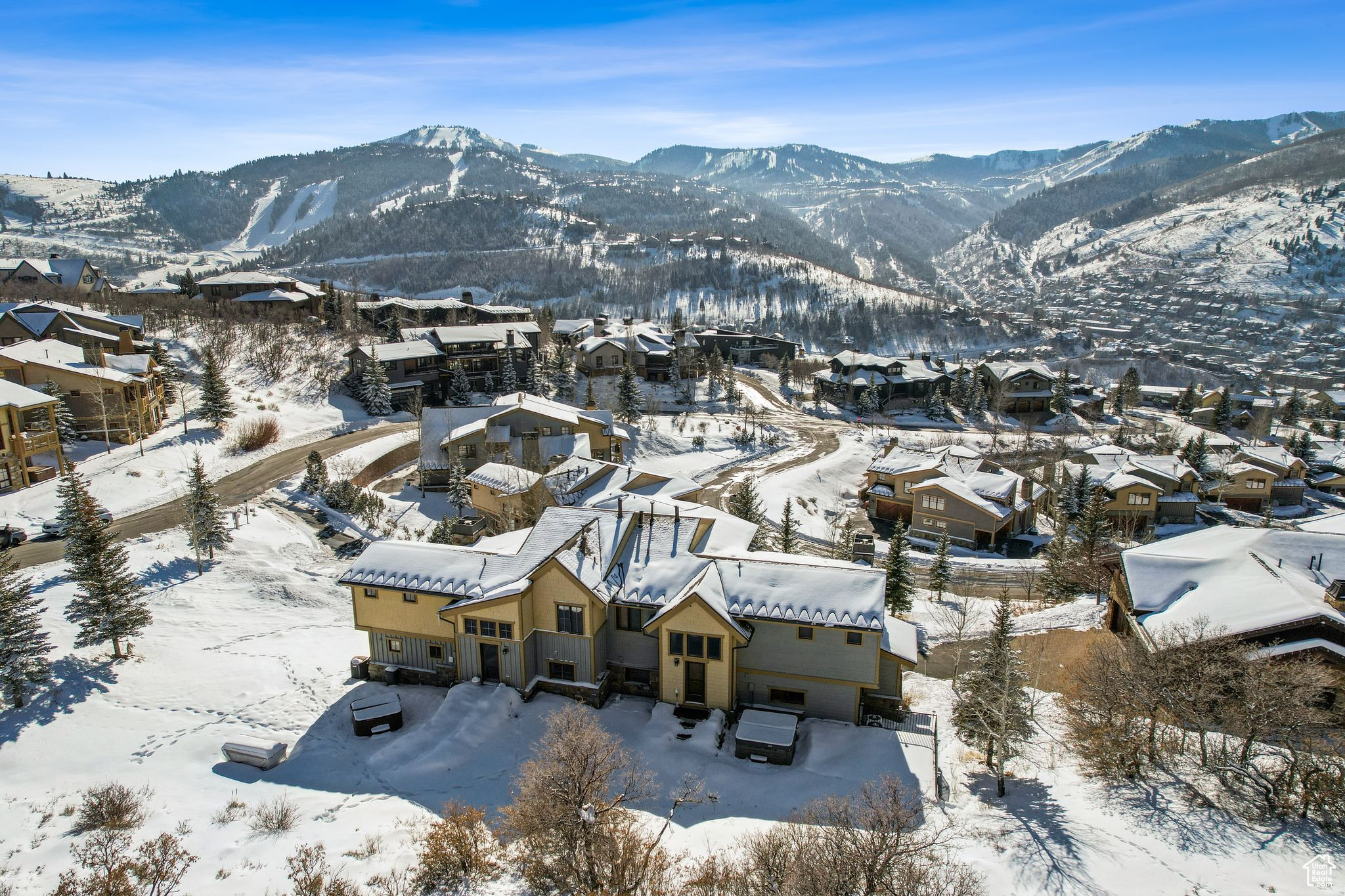 ELEVATED LIVING IN APRIL MOUNTAIN WITH SKI RESORT VIEWS  This stunning 2,855 sq ft townhome in the exclusive April Mountain subdivision of the Aerie neighborhood offers an exceptional blend of luxury, comfort, and natural beauty. With four bedrooms and four bathrooms, this thoughtfully designed home is perfect for entertaining and relaxing.  On the main level, the great room features vaulted ceilings, a striking stone fireplace converted to gas, and expansive windows showcasing stunning ski resort views. The kitchen is well-appointed with granite countertops, a gas stove, and ample storage, flowing seamlessly into the dining area. Step from the great room onto the large patio, perfect for sunset dinners, or access the backyard retreat, complete with a hot tub, dining area, and firepit for year-round enjoyment. A guest suite with a full bathroom completes this level.  The upper level is home to the luxurious primary suite, where you can wake up to commanding mountain views. The suite offers a serene retreat with ample space and elegance. An additional bedroom suite on this level provides a cozy and private space for family or guests. The lower level includes a charming bunk room suite  a versatile space perfect for kids, guests, or a casual hangout area, and a convenient oversized two-car garage with ample storage.   This property has been tastefully remodeled with fresh paint, new light fixtures, A/C installation, smart thermostats, a smart lock, and security cameras. Additional updates include a new roof (approximately 2.5 years ago), new appliances (washer, dryer, and refrigerator in the laundry room), TV mounts, and updated furniture.  Situated between Old Town and Deer Valley Resort, this home is close to Park City's world-class amenities and outdoor recreation. Nearby trails and the tranquil April Mountain community make this an ideal primary residence or luxurious second home.