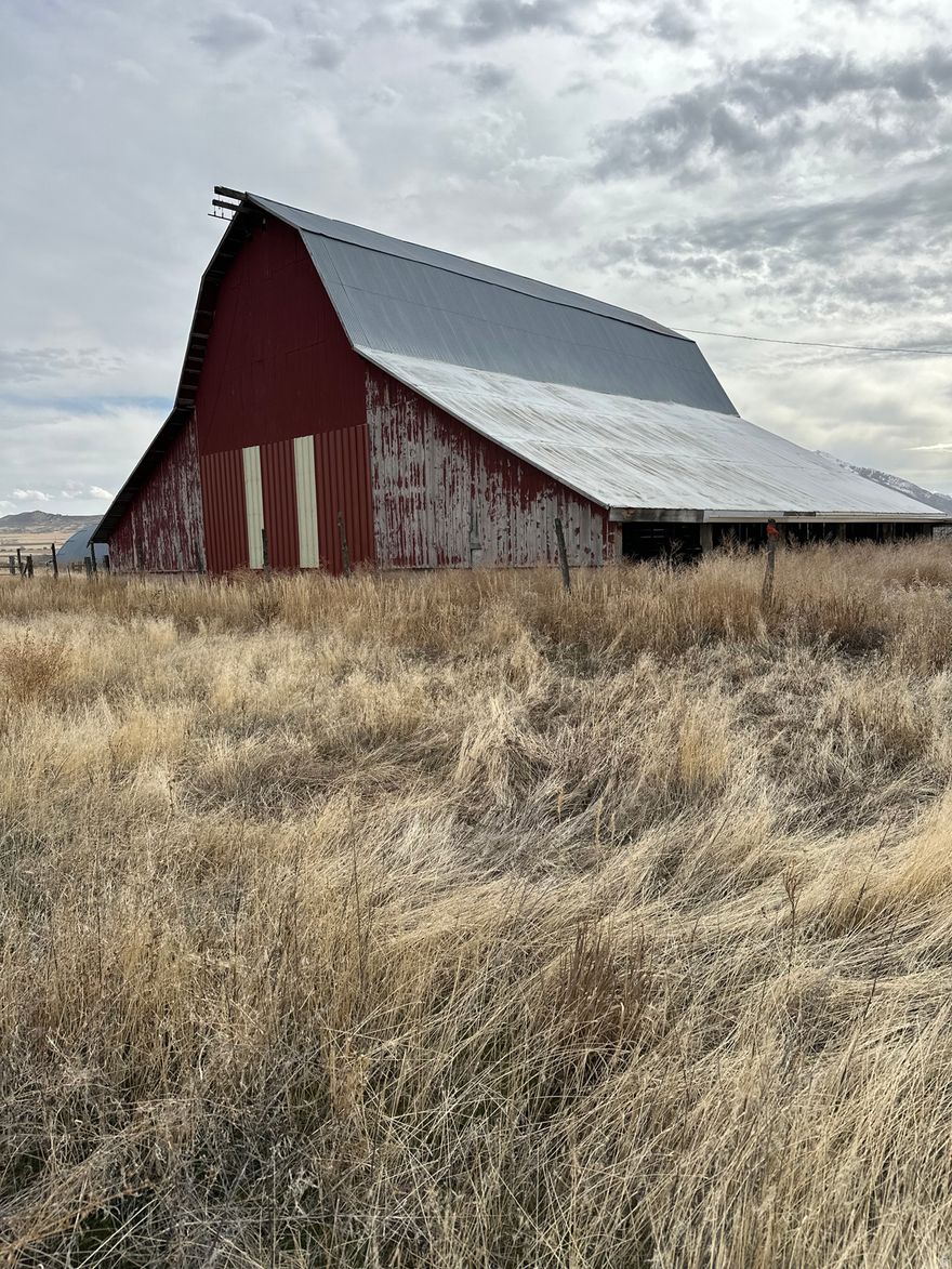 Opportunity meets potential on this 0.87-acre rural Box Elder County property featuring a large turn of the- century barn and space to build your dream home.  With room for animals and country living at its finest, this lot offers flexibility and character you won't find in newer subdivisions. The existing outbuildings provide options for storage or future use , and with a little vision, you can transform this property into the ideal homesite.  Culinary water, and power will be stubbed to the lot. Sewer will be septic.  If you're looking for land with personality, usable space, and the freedom to create your own vision, this property is ready for its next chapter.