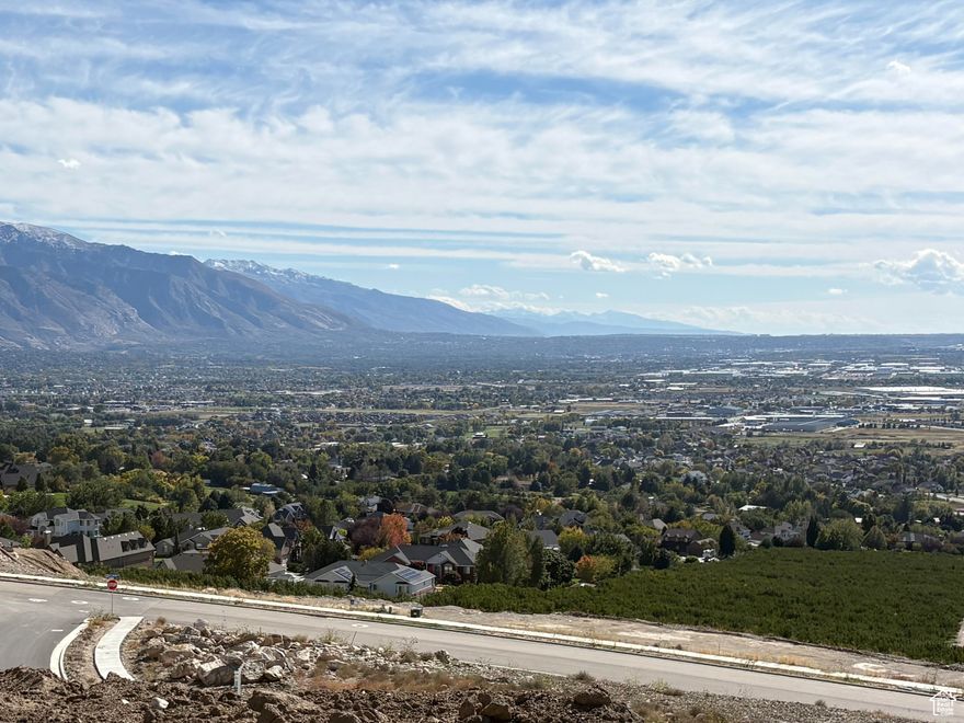 Nestled High on the Beautiful Pleasant View Bench, this stunning 0.40-Acre lot showcases sweeping Mountain and valley views along with breathtaking sunsets. The property offers the perfect setting for a custom home designed to highlight the area's natural beauty and serene surroundings. Enjoy the peaceful atmosphere while being just minutes away from hiking trails, skiing, parks, and local conveniences. this rare view lot provides an exceptional opportunity to build your dream home in one of Pleasant View's most desirable locations.