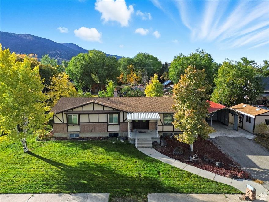 Welcome home to this spacious and cozy home located in the heart of beautiful Manti, Utah! This spacious 5-bedroom, 3-bath home offers comfort, functionality, and small-town charm on a fully landscaped .32 acre lot. Inside, you'll find two large family rooms, two laundry areas,  and a semi-formal dining room -perfect for gathering and entertaining. The inviting layout provides plenty of space for everyday living with room to grow. The basement features a cozy dry bar, walkout basement, gas fireplace,  a large food storage room, and additional space that's ideal for a home gym, craft area, or playroom. Step outside to enjoy the fully landscaped yard with mature trees, lush grass, and open space for kids and pets to play. The extra-large deck is the perfect place to enjoy evening dining or take in the stunning mountain views. A convenient carport provides off-street parking, and the property includes a storage shed with power for tools or outdoor gear. Located close to schools, parks, and downtown amenities, this home combines practicality, comfort, and a peaceful setting. Come see why this charming property is the perfect place to call home in Manti! Square footage figures are provided as a courtesy estimate only and were obtained from the Sanpete County Recorder's office.  Buyer is advised to obtain an independent measurement.