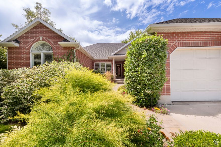Exquisite all brick rambler with simply amazing character and charm. This custom-built gem is surrounded by lush gardens, paver patios, and a delightful entry courtyard. The patio sprawls across the back with a covered area plus a large freestanding pergola. There is a sitting area with a firepit. This is the ultimate outdoor living situation. Wide-open spaces have tall ceilings or vaults on the main. The primary suite is separate and private. The lovely kitchen opens to a cozy family area with fireplace and built ins. The formals are beautiful. Downstairs, a distinctive river rock fireplace warms a huge rec area with a full kitchen adjacent. The rooms are large and bright. This house has a great flow and feel. Note the top-grade architectural asphalt shingles, the big triple garage, and top-notch condition! The best option out there!