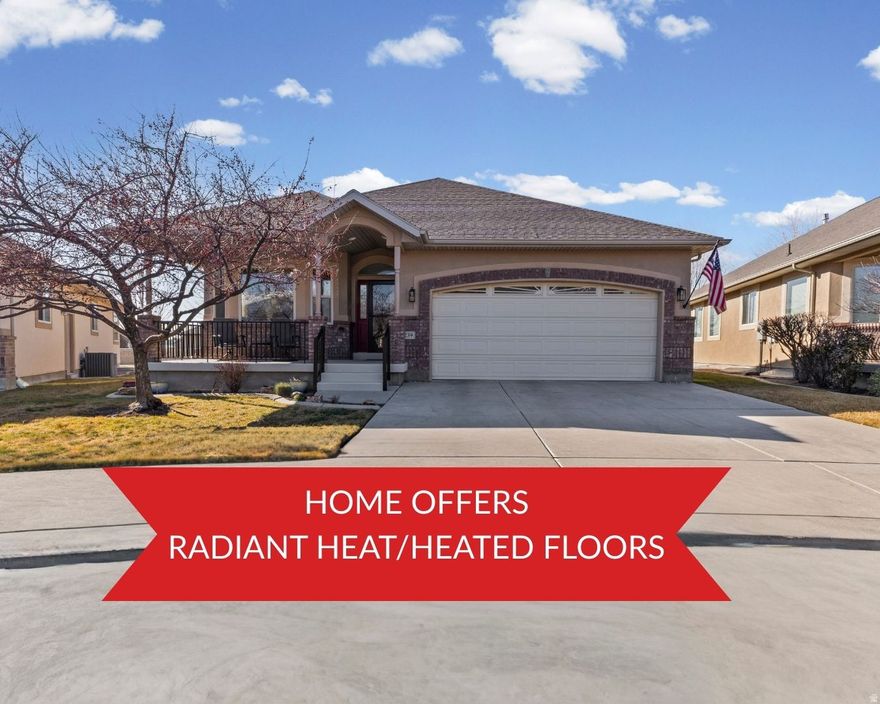 Welcome to one of the finest homes in this highly sought-after 55+ Lehi community, where comfort, quality, and lifestyle come together seamlessly. This beautifully maintained rambler is packed with premium upgrades, starting with a radiant heated floor system featuring individual thermostat controls in nearly every room, creating year-round comfort and energy efficiency. As you arrive, you'll be welcomed by a charming covered front porch, the perfect place to enjoy your morning drink and good book. Inside, the home opens to a bright sitting room, office, or flexible living space that faces east and captures stunning mountain views. This room features bay windows, a ceiling fan, and abundant natural light, making it ideal for quiet mornings or productive afternoons. The chef's kitchen is a true showpiece, thoughtfully designed with both function and elegance in mind. All appliances have been replaced within the last five years and include double ovens, a gas range, and a large walk-in pantry. Additional highlights include tile flooring, quartz countertops, a modern tile backsplash, updated faucet, and a large peninsula island with bar seating. The open-concept layout flows effortlessly into the spacious family room, which features newer flooring, a ceiling fan, custom built-in cabinetry with drawers, and a modern gas fireplace with blower-perfect for cozy evenings at home. There is also ample space for a semi-formal dining area. From the family room, step out onto the covered back deck, an ideal setting for hosting family, entertaining friends, or enjoying peaceful evenings outdoors. The main level also includes a generously sized bedroom with a ceiling fan, along with a conveniently located laundry room offering extensive cabinetry and storage. The main-level bathroom is beautifully finished, featuring comfort-height toilets, a three-quarter shower with European glass, tile flooring, and ample storage. The primary suite is a true retreat, offering a spacious layout, ceiling fan, direct access to the back deck, and beautiful western mountain views. The luxurious en suite bathroom includes a jetted tub, separate shower with European glass, tile flooring, ample storage, and a large walk-in closet with built-in shelving. Descending to the basement, you'll notice elegant rod-iron railings and tile flooring leading to an expansive lower-level living space. The basement features a large family room with a fireplace, built-in shelving, and an open layout that includes a kitchenette with LVP flooring and a semi-formal dining area-perfect for hosting guests or extended family. There is also a flexible multipurpose room ideal for an office, craft room, or hobby space, along with a large workspace and two separate storage rooms with extensive shelving. The basement bathroom continues the home's high-end finishes, offering European glass, tile flooring, comfort-height toilets, and ample storage. Two additional well-sized bedrooms complete the lower level. The spacious backyard provides room for visiting family and grandkids to enjoy. Additional features include a new air-conditioning unit (2020), adjustable shelving throughout the home, a new water softener, a boiler system supporting radiant heated floors, radon mitigation system, gutter filtration system (no more cleaning gutters), central vacuum system, and a finished garage with epoxy floors, fresh paint, whole home speaker system/communication system, and extensive storage. Location is exceptional, with direct access to the Murdock Trail, quick freeway access, and close proximity to Thanksgiving Point, American Fork, shopping, dining, and everyday conveniences. The HOA is truly outstanding, offering a community garden, monthly social activities, pool, gym, ballroom, pavilion, grills, kitchen, dining room, clubhouse, and more-designed to support an active, social, and low-maintenance lifestyle. This home and community offer an incredible opportunity to enjoy refined living in a welcomi