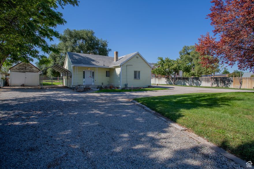 Super cute West Jordan bungalow that is close to everything! Schools, shopping, all of it. Very clean and well maintained. Tile floors and beautiful alder cabinets make this kitchen a dream. 2 nice sized bedrooms and 1.5 baths. Wood burning fireplace in family room will keep the entire home toasty warm, even on the coldest of days. Detached one car garage is extra long and could be utilized for a work shop or storage also. Bonus carport allows for more vehicle protection from the elements.  Shed where the pump for the well water is large and can also be used for storage. Spacious yard with room to add on. Grow a garden! Well water can be used to keep the landscaping green and healthy. Additional .34 acre flat flag lot available for purchase also. See MLS #2118861. Call for a private tour today.