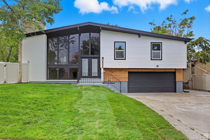 This beautifully updated home has been completely transformed with top-quality finishes throughout. From the brand-new flooring to upgraded electrical and plumbing, no detail has been overlooked. The stylish new exterior pairs perfectly with the modern, open-concept interior featuring neutral tones that suit any dcor.  The kitchen is a standout with its white shaker cabinets, quartz countertops, and stainless steel appliances-ideal for hosting and everyday living. The spacious primary suite offers two closets and opens onto a private Trex balcony, creating a relaxing personal retreat.  Additional features include a newly built deck overlooking a professionally landscaped yard, complete with an automated drip and sprinkler system. You'll also appreciate the new garage door opener, water heater, and a recently replaced roof for added peace of mind. Located in a quiet, well-established neighborhood with easy access to schools, shopping, and major commuter routes-this home truly has it all!