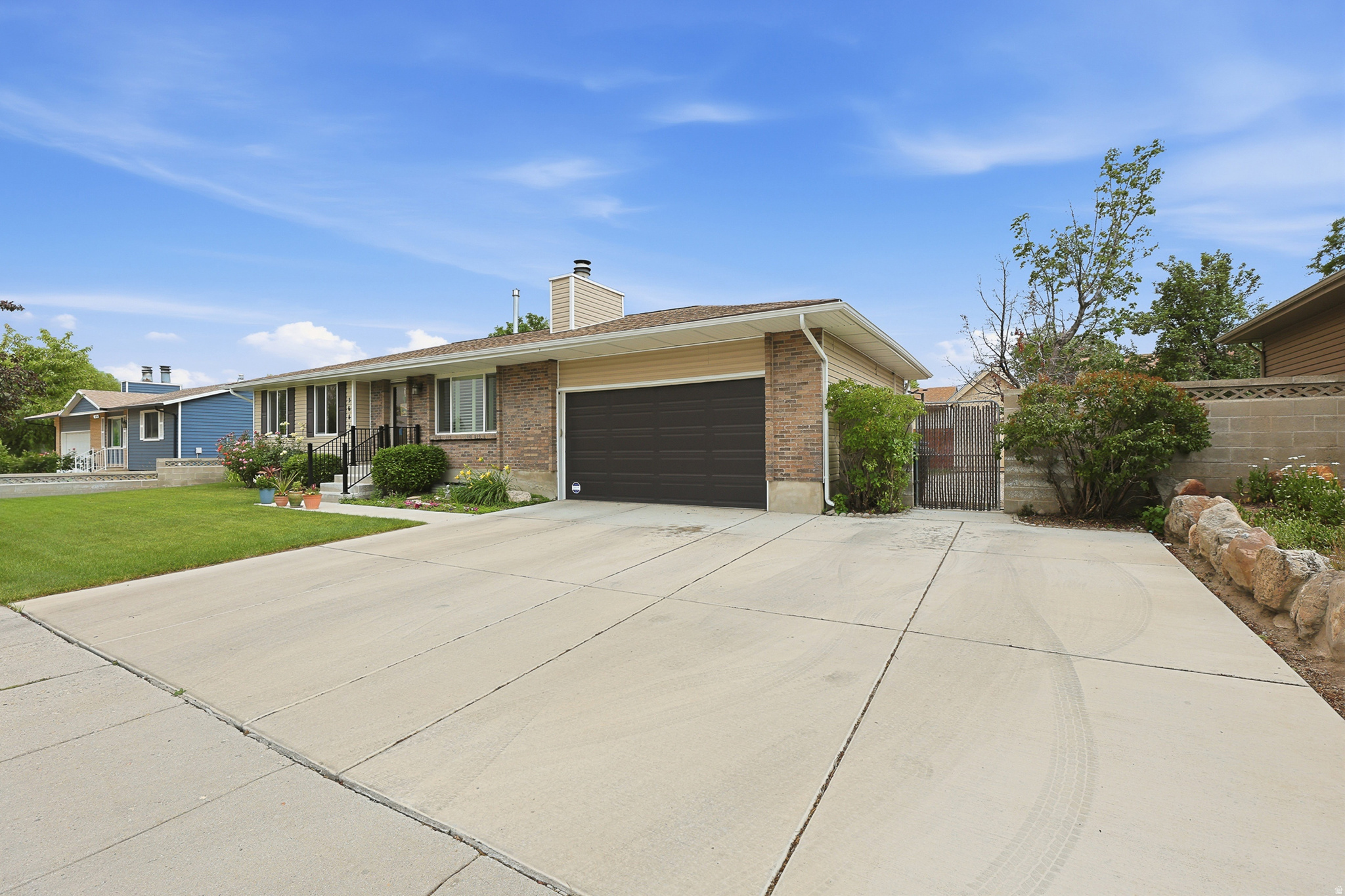 Brick and siding exterior with a dark brown garage door