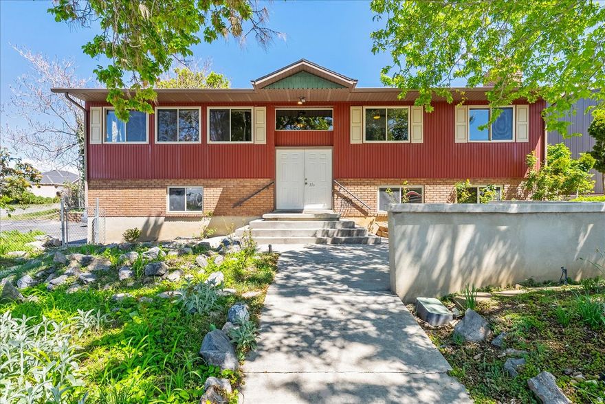 This stunning 6-bedroom, 3-bath home in Elk Ridge offers plenty of space and style. Step outside to a large covered deck with gorgeous views of the professionally landscaped backyard-perfect for BBQs or quiet evenings. The oversized covered RV garage gives you tons of parking and storage for all your gear.  Beautiful curb appeal, roomy interiors, and a prime location make this home a must-see. Ready for your family to move in!     Square footage figures are provided as a courtesy estimate only and were obtained from the County .  Buyer is advised to obtain an independent measurement.