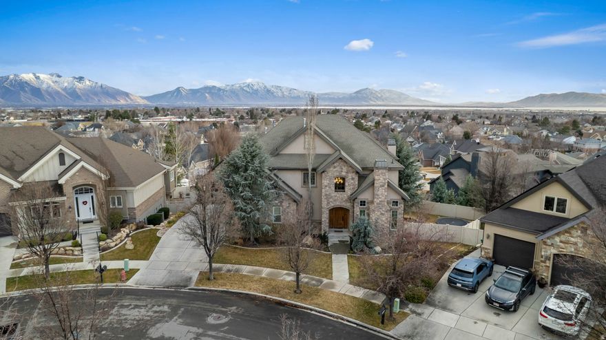 Jump into Spring with a new home. This exceptional home offers space, functionality, and stunning valley views. Featuring 6 bedrooms, 5 bathrooms, two family rooms, an office/den, formal dining room, flex area, and a 4-car garage plus a fully finished workshop, there is room for everyone and everything. The open-concept floor plan provides flexibility for daily living and entertaining. The spacious primary suite includes a luxurious ensuite with dual tub and shower, a large walk-in closet, and picturesque valley views. Expansive windows throughout fill the home with natural light while highlighting the surrounding scenery. Buyers will appreciate the abundant garage and workshop space, perfect for storage, hobbies, or projects. Square footage figures are provided as a courtesy estimate only and were obtained from Utah County Records. Buyer is advised to obtain an independent measurement.