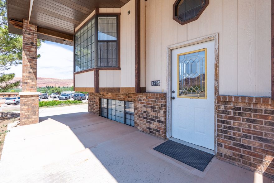 This custom 3-bedroom, 3-bathroom home was built in 1992 by an excellent, well-known local builder and features custom Al Heaton cabinets throughout with lots of parking and room to grow. The property is situated on a quarter-acre lot just off the highway in a less traveled neighborhood in Moab and offers main level living complete with a kitchen, livingroom, and 3 bedrooms including the master suite. The partial daylight basement features an office area, a family room, utility/laundry room, 1 full bath and abundance of storage. This home also has a lot parking options, including covered parking on the south side for main-level access with carport, plus an attached built-in tandem 2 car garage on the north lower side of the lot with an extra large concrete driveway with direct entry to the basement. The daylight basement provides significant flexibility with separate access. Recent updates include some high-priced maintenance items offering long-term peace of mind including a new roof (2024), a replaced main water line (2024), and a new refrigerator (2025). This is a solid, well built home ready for your personal touch with a great layout and space to adapt to your specific needs.  Square footage figures do not match county, buyer is advised to obtain an independent measurement.