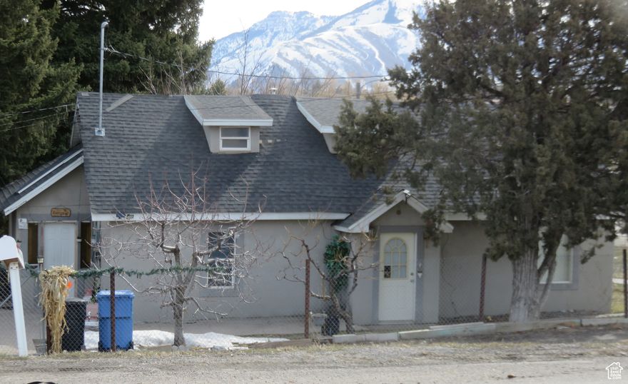Great home and property to work from home or as an investment opportunity! County has current use as residential. It is a non-conforming property. Hyrum City has zoning as C-2 multi-use. Entrances are off Main Street and 400 West. Possible for live-work units, daycare, karate space, auto shop, and more....  Call Hyrum City to verify your business idea and requirements. See commercial MLS # 2060465.  Square footage figures are provided as a courtesy estimate only. Buyer is advised to obtain an independent measurement.