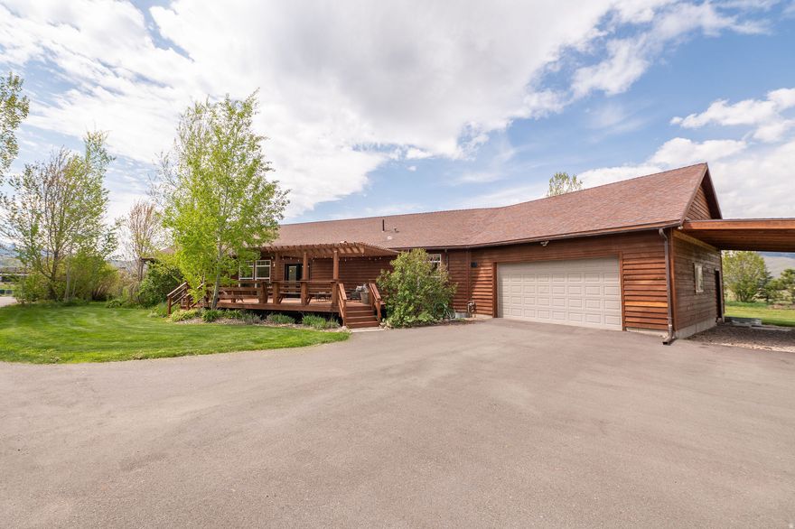 Wake up to peaceful country living on 5.05 acres in this 3-bed, 2-bath, 2,114 sq ft home. Start your morning gathering fresh eggs, tending the garden, or walking through your permaculture orchard and hay field. Enjoy an open layout with a living room filled with natural light and views of the Wasatch Mountains and Snowbasin Ski Resort. Make memories cooking in a spacious kitchen featuring a butcher block island, breakfast bar & pantry. Unload groceries with ease through the mudroom off the attached 2-car garage. Spend your afternoons in the heated shop with a loft + bonus room, perfect for hobbies, a workshop, or she-shed. Entertain on one of three sunny decks. Park your RV under covered carports, then wind down in the evening in your private primary suite with ensuite bath, jetted tub, separate shower & walk-in closet...or end the day unwinding in your cedar sauna. It's not too good to be true, see it for yourself! Square footage figures are provided as a courtesy estimate only and were obtained from county records.  Buyer is advised to obtain an independent measurement.