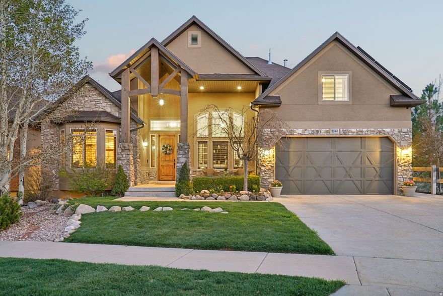 Experience "top of the world" living in this stunning executive home, perfectly situated within the Suncrest community to capture unobstructed, majestic views of Lone Peak, Utah Lake, and the Timpanogos Range. Step inside to soaring vaulted ceilings and an open-concept great room anchored by a floor-to-ceiling stacked stone fireplace and oversized windows that frame the valley below. The main-floor primary suite is a true retreat, featuring its own cozy fireplace and breathtaking views. Enjoy a serene morning routine in the light filled en-suite, featuring the ultimate comfort of heated flooring. The fully finished walk-out basement is a standout feature, offering an in-law suite complete with a second gourmet kitchen, dining area, two spacious bedrooms, media/entertaining space, and a laundry room-perfect for multi-generational living or a high-end guest haven. Enjoy quiet evenings in the outdoor hot tub on the oversized deck, or world-class Eagle Crest hiking and biking trails. With a solar array covering nearly all power costs, this home offers luxury living with a practical, energy-efficient edge. Come see all this home has to offer. Floor to ceiling renovations (including paint, flooring, stairs, baseboards, refrigerators, cooktops, indoor and outdoor lighting, bathroom fixtures, ceiling fans, window treatments) completed within the last two years. Pre-wired surround sound system with 7 speakers in the family room, 2 speakers in the formal dining room, and speakers in the backyard. Primary bedroom is also pre-wired for 6 speakers. Primary suite on main floor and 3 bedrooms on upper floor. Large 450+ sq ft of additional cold storage. Three-car garage with workbench, EV charging outlets, and an oversized driveway. Energy Efficiency - 42 panel solar system and all window panes replaced in 2025.