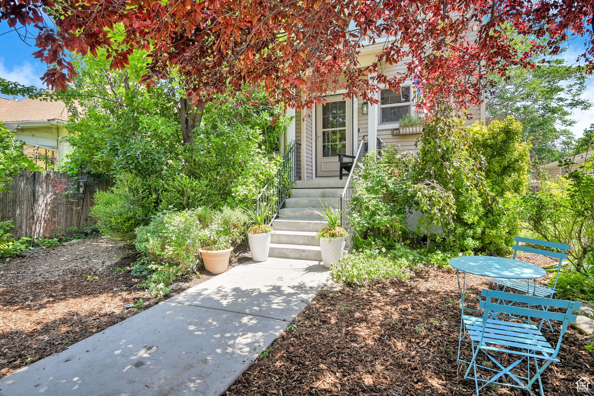 Welcome to your urban sanctuary, through the garden gate and up the stairs into this cheerful city retreat. Inside, you'll be greeted by abundant natural light, vaulted ceilings, and a warm, inviting atmosphere. The home features updated laminate flooring, refreshed bathrooms, and a finished basement with a modern kitchen-making everyday living both comfortable and convenient. The spacious backyard offers endless potential to bring your outdoor dreams to life, with alley access, electricity and a concrete pad already in place for added flexibility. Appliances are included as is the stylish electric fireplace. Enjoy quick and easy access to the airport, downtown, major freeways, the library, Jordan River Parkway, and more.