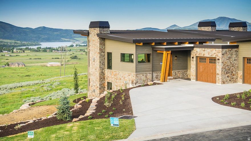 Experience luxury mountain living in The Ridge at Wolf Creek Resort, located in the heart of Eden, Utah. This spacious end-unit Sunrise Plan townhome offers 3,231 sq/ft with 4 bedrooms and 4.5 baths, including a main-level master suite for effortless living. As an end unit, it features additional windows that capture even more of the surrounding valley and mountain scenery. Warm mountain finishes include knotty alder trim, baseboards, and doors, two beautiful stone fireplaces, and radiant heat on the lower level. An elevated deck extends the living space outdoors and showcases the stunning views. A 2-car garage provides ample storage for year-round gear. Wolf Creek Resort sits just eight miles from Powder Mountain and minutes from Snowbasin and Nordic Valley ski resorts, placing world-class skiing within easy reach. Pineview Reservoir is less than a ten-minute drive for boating, swimming, paddleboarding, and water skiing. Endless nearby trails offer mountain biking, hiking, and jogging, while Monte Cristo and neighboring terrain provide exceptional snowmobiling access-making this a true year-round outdoor recreation paradise. This home is part of the closeout phase of The Ridge townhomes, with the community pool and hot tub already complete, both showcasing incredible panoramic views. Wolf Creek's public golf course is directly across the street, offering a stunning mountain backdrop to every round.