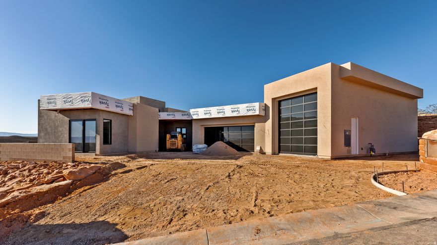 Perched near the top of the gated enclave- Westgate Hills, this single-level home takes in sweeping views of Pine Valley Mtn, sandstone cliffs, city lights & crimson ridges to the south. Set on a private -acre lot, it features a 43-ft RV garage w/12'x14' door, 3-car garage & RV pad. Outdoor living shines w/ heated pool, spa, waterfall feature, shamu shelf & auto cover. Inside: 5 beds (5th as office w/view), glass media room, private guest suite with incredible views, a chef's kitchen w/ custom cabinets, high-end countertops & appliances, large working pantry w/southern mountain views + an additional storage pantry. Primary retreat has a large window that perfectly captures Pine Valley Mtn views, has a spa-like bath & spacious closet w/ laundry hookups. Est. completion Jan 2026.