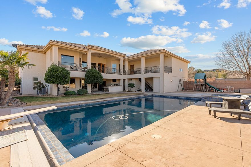 our very own PRIVATE Virgin River Equestrian Estate on 2 ACRES with all your DREAM FEATURES, stunning VIEWS and the ultimate OUTDOOR LIVING. This fine LUXURY CRAFTED home is finished with engineered hardwood and travertine flooring throughout. The Main WALK-OUT BASEMENT Home is 5,800 sq. ft. w/ 6 bedrooms, 4 full bathrooms, & 2 half bathrooms & 2 large gathering areas. The Primary Owner Suite is on the MAIN LEVEL and the 2nd OWNER SUITE is in the basement. The spacious kitchen has 2 COPPER SINKS, Built-in APPLIANCES and GIANT HIDDEN PANTRY. The basement has a FULL 2nd KITCHEN, private THEATER with all the equipment, a 2nd LAUNDRY Room & several storage rooms. The detached GUEST QUARTERS / ADU is 600+ Sq. Ft. and comes with 1 Bedroom, 1 Bathroom, laundry area and full kitchen.  The RV GARAGE is insulated with a mini-split system and includes a car lift. Total garage space is 2305 Sq. Ft., so tons of parking for cars, trailers and toys. This estate is ideal for hobby farm and very animal friendly w/ horse corrals, tack shed, and pastor w/ access to the Virgin River. The BACKYARD OASIS includes a pristine SWIMMING POOL, hot tub, playground, full bathroom and BUILT-IN BBQ. 3,000 sq. ft. of COVERED PATIO space for beautiful views of Pinevalley Mountain, Virgin River and the Red Rock Candy Cliffs.