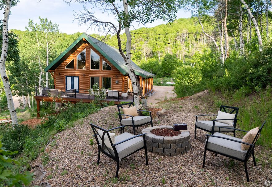 Discover the ultimate mountain retreat where adventure meets elegance. Located on over an acre of land on a peaceful dead end street in the coveted Tollgate community, this 4 bedroom, 3 bathroom, mountain contemporary cabin offers a rare combination of modern comfort, family functionality, and all season recreation, perfect for those seeking a high-end escape or a legacy family property. Featuring 2,675 sq/ft finished sq/ft and an additional 406 sq/ft attached and heated garage. Step inside and you're immediately welcomed by light-filled living spaces, an open concept kitchen, a versatile loft, and seamless indoor-outdoor flow to a spacious deck with breathtaking views of the valley and surrounding aspen grove. The oversized attached gear room is a dream come true, designed to house ATV's, bikes, snow equipment, skis, snowboards, paddleboards, and everything your mountain lifestyle demands. Uniquely designed to have flat areas of usable yard, this property welcomes the opportunity to fully embrace the outdoors. Roast marshmallows around the firepit tucked into the aspens, or watch the kids play while taking in the tranquil scenery. The community's semi-private roads invite year-round exploration whether you're skiing, snowmobiling, hiking, biking, or cruising in a side-by-side from your own doorstep. This is more than just a home it's a foundation for future possibilities. An adjacent lot is available, offering the rare option to expand your space, build a second home, or create a multi-generational retreat. Whether you're looking for a peaceful family getaway, a basecamp for adventure, or a luxurious year-round residence, this quiet mountain sanctuary is where your next chapter begins.