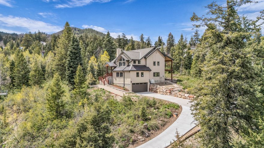 This tastefully updated 4-bedroom, 3-bath mountain retreat delivers the perfect blend of modern design, natural light, and year-round living.   Inside, a dramatic great room welcomes you with soaring ceilings, a striking fireplace, and a wall of windows that frames the surrounding forest and fills the home with light. The inviting floorplan flows naturally into a completely renovated kitchen featuring new cabinetry, granite and quartz countertops, stainless steel appliances, and an oversized island designed for gathering and entertaining.  Thoughtful, modern updates extend throughout the home, including French oak flooring, fresh paint, new sliding glass doors, beautifully remodeled bathrooms, and updated lighting and plumbing. A heated driveway with a new boiler and desirable south-facing exposure adds everyday convenience, while heat tape and extensive exterior siding improvements provide long-term peace of mind. The primary suite offers a true retreat, enhanced by a private deck and a spa-like bathroom with heated floors, a freestanding soaking tub framed by serene views, and a walk-in glass rainfall shower. Outdoor living is just as impressive, with a private covered patio perfectly positioned to enjoy the natural surroundings in every season.   Ideally located in Park City, this home offers a convenient commute to Salt Lake City without the burden of ski traffic. Just minutes from Kimball Junction's shopping and dining, Woodward Park City, and world-class ski resorts, it delivers a seamless blend of design, function, and lifestyle.