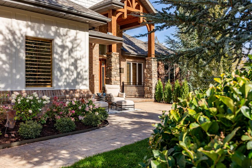 Perched gracefully on a beautiful hillside, this custom-built residence offers timeless sophistication and breathtaking views in every direction. Thoughtfully designed with soaring ceilings, walls of windows, and a light-filled walk-out lower level that lives like the main floor. Highlights include a stunning home office with mountain views, a flexible 5th bedroom/office/gym, large secondary bedrooms, abundant storage, and an oversized garage with extensive built-in cabinetry. Outdoor spaces feature tranquil waterfalls, a built-in BBQ kitchen, and sweeping vistas-even from the basement-creating a seamless blend of elegance, comfort, and natural beauty.